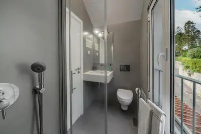 a bathroom with a toilet and a sink and a shower at OurMadeira - Babosas Village in Funchal