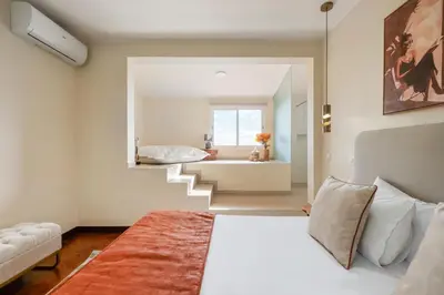 a bathroom with a toilet and two sinks and a shower at Funchal Bay View Villa by Homie in Funchal