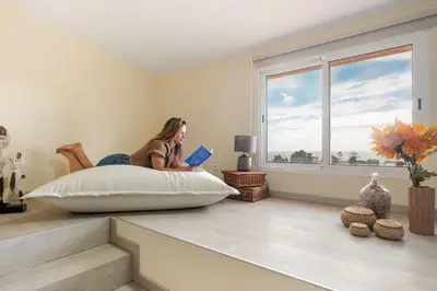 a bedroom with two beds and a large window at Funchal Bay View Villa by Homie in Funchal