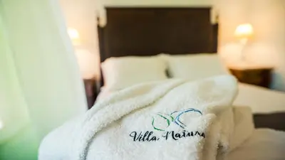 a hotel room with a towel on a bed at Villa Natura in Vila do Porto