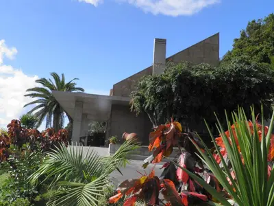 a building with a bunch of plants in front of it at Villa Natura in Vila do Porto