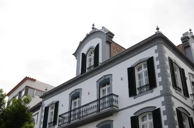 a white building with a balcony on top of it at Edifício Charles 203 in Funchal
