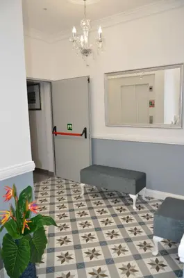 a waiting room with a mirror and a table at Edifício Charles 203 in Funchal