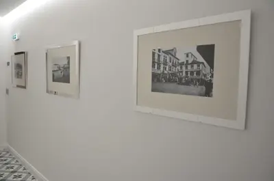 a row of framed photographs on a white wall at Edificio Charles 104 in Funchal