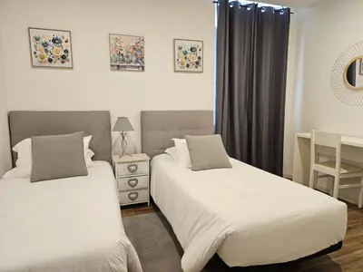 a bedroom with two beds and a window at Mary Jane Apartment Funchal by Rentallido in Funchal