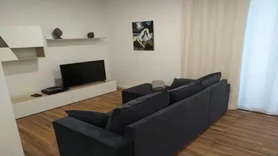 a living room with a black couch and a tv at Mary Jane Apartment Funchal by Rentallido in Funchal