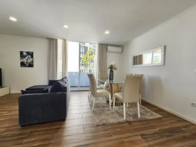 a living room with a couch and a table and chairs at Mary Jane Apartment Funchal by Rentallido in Funchal