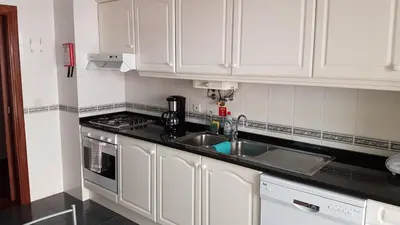 a kitchen with white cabinets and a sink at Dorisol I Casa Branca Apartment by Rentallido in Funchal