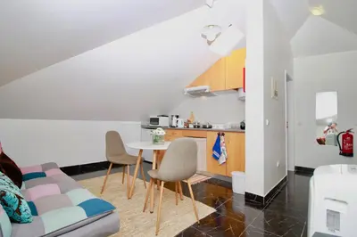 a kitchen with a table and chairs in a room at Casa Maria in Funchal