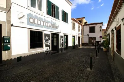 an empty street in an old town with a building at Casa Maria in Funchal