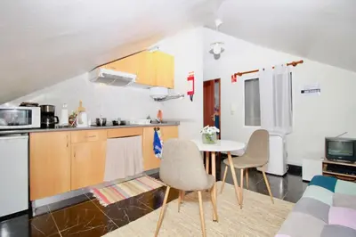 a kitchen with a table and chairs in a room at Casa Maria in Funchal