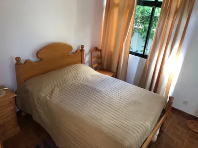 a bedroom with a bed and a window at Quinta da quebrada in Santana