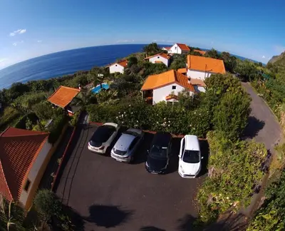 a group of cars parked in a parking lot at Quinta da quebrada in Santana