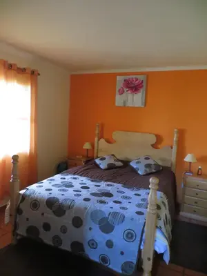 a bedroom with a bed with a blue and black comforter at Quinta da quebrada in Santana