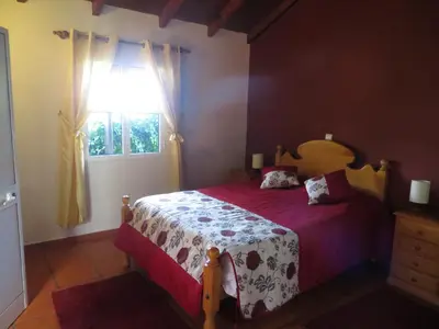 a bedroom with a bed and a window at Quinta da quebrada in Santana