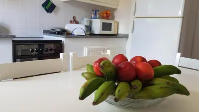 a bowl of fruit on a counter in a kitchen at Casa do Cisne in Porto Santo