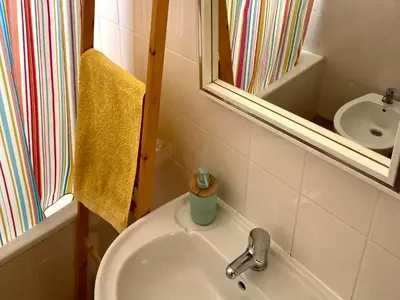 a bathroom with a sink and a mirror at Casa do Cisne in Porto Santo