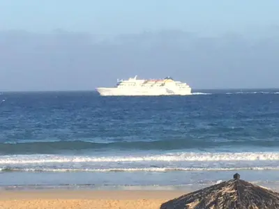 a cruise ship in the ocean with a beach at Cantinho Solpraia in Porto Santo