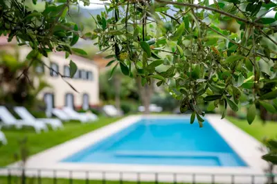 a swimming pool in front of a house at Casa Da Piedade in São Vicente