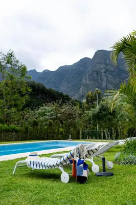 a toy airplane sitting on the grass near a pool at Casa Da Piedade in São Vicente