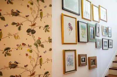 a wall of framed pictures on a wall at Casa Da Piedade in São Vicente