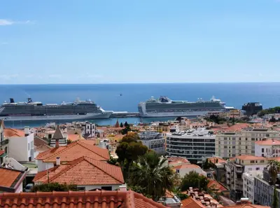 two cruise ships docked in the ocean with buildings at Luxury Apartment Living Funchal in Funchal