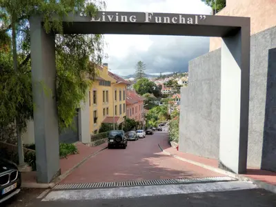 an archway over a street with cars parked at Luxury Apartment Living Funchal in Funchal