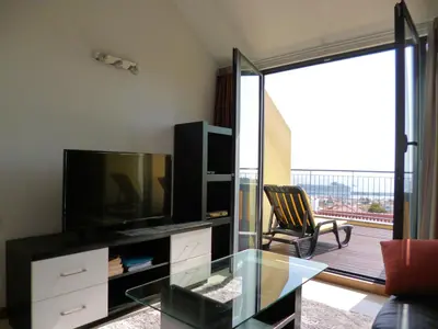 a living room with a tv and a glass table at Luxury Apartment Living Funchal in Funchal