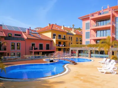 a swimming pool in front of a group of buildings at Luxury Apartment Living Funchal in Funchal