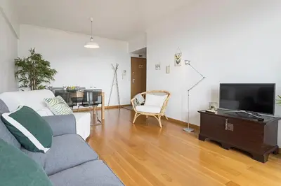 a living room with a couch and a tv at Barreiros I by An Island Apart in Funchal