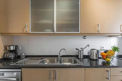 a kitchen with a sink and some fruit on the counter at Barreiros I by An Island Apart in Funchal