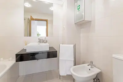 a white bathroom with a sink and a toilet at Barreiros I by An Island Apart in Funchal