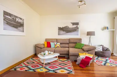 a living room with a couch and a table at The Cliff Side Apartment in Funchal