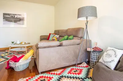 a living room with a couch and a lamp at The Cliff Side Apartment in Funchal