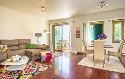 a living room with a couch and a table at The Cliff Side Apartment in Funchal