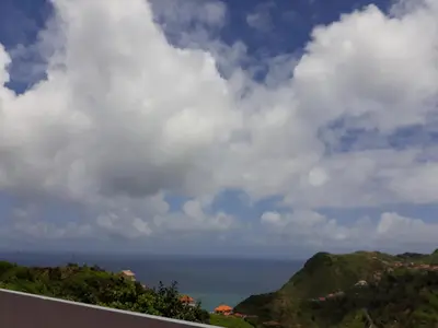 a view of the ocean from the balcony of a house at Vista Boa in Porto da Cruz
