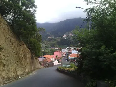 a winding road in a town on a mountain at Vista Boa in Porto da Cruz