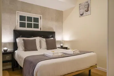 a bedroom with a large bed with towels on it at Cantinho das Feiteiras by Homie in São Vicente
