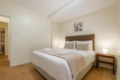 a bedroom with a large bed with two towels on it at Cantinho das Feiteiras by Homie in São Vicente