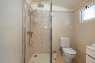 a bathroom with a shower and a toilet at Cantinho das Feiteiras by Homie in São Vicente