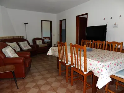 a living room with a table and chairs and a couch at Moradia Vale da Telha in Aljezur