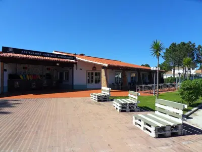 a group of benches in front of a building at Moradia Vale da Telha in Aljezur