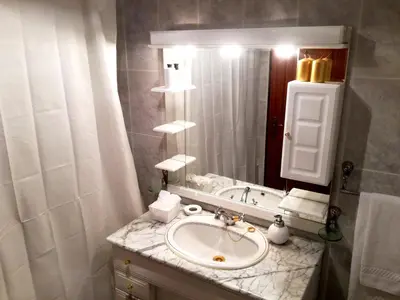 a bathroom with a sink and a mirror at Villa Palmeiras in Funchal