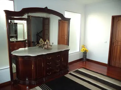 a room with a large mirror and a wooden dresser at Villa Palmeiras in Funchal