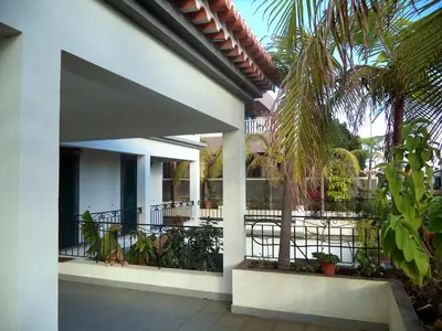 a white house with a balcony with plants at Villa Palmeiras in Funchal