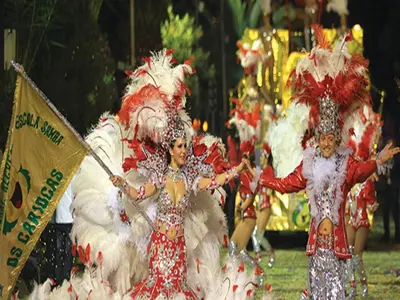 a group of women in costumes standing in a parade at Villa Palmeiras in Funchal