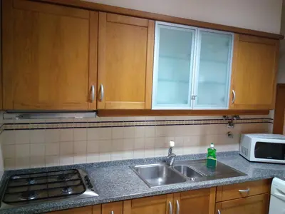 a kitchen with a sink and a microwave at Sea Balcony in Funchal