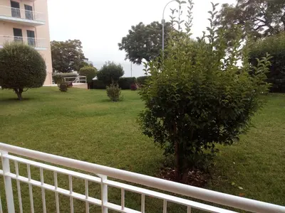 a white fence in a yard with a tree at Sea Balcony in Funchal