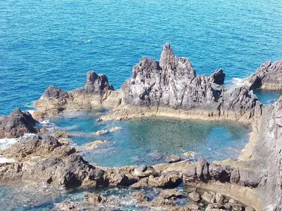 an island in the ocean with rocks in the water at Sea Balcony in Funchal