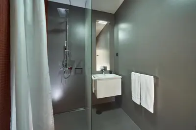 a bathroom with a shower and a sink and a mirror at Funchal Charming Villa in Funchal